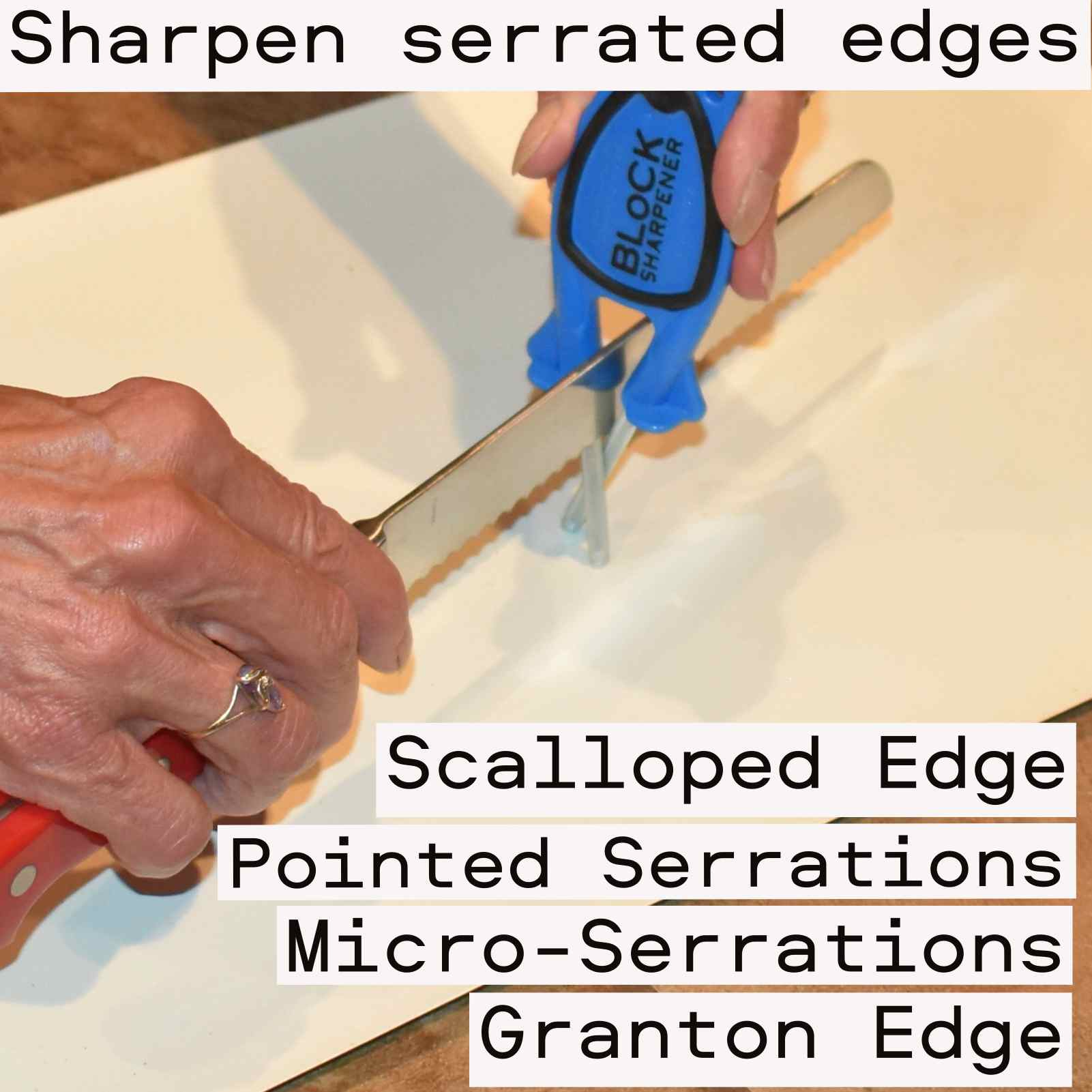 Person sharpening a red‑handled serrated knife with a blue and black Block Sharpener