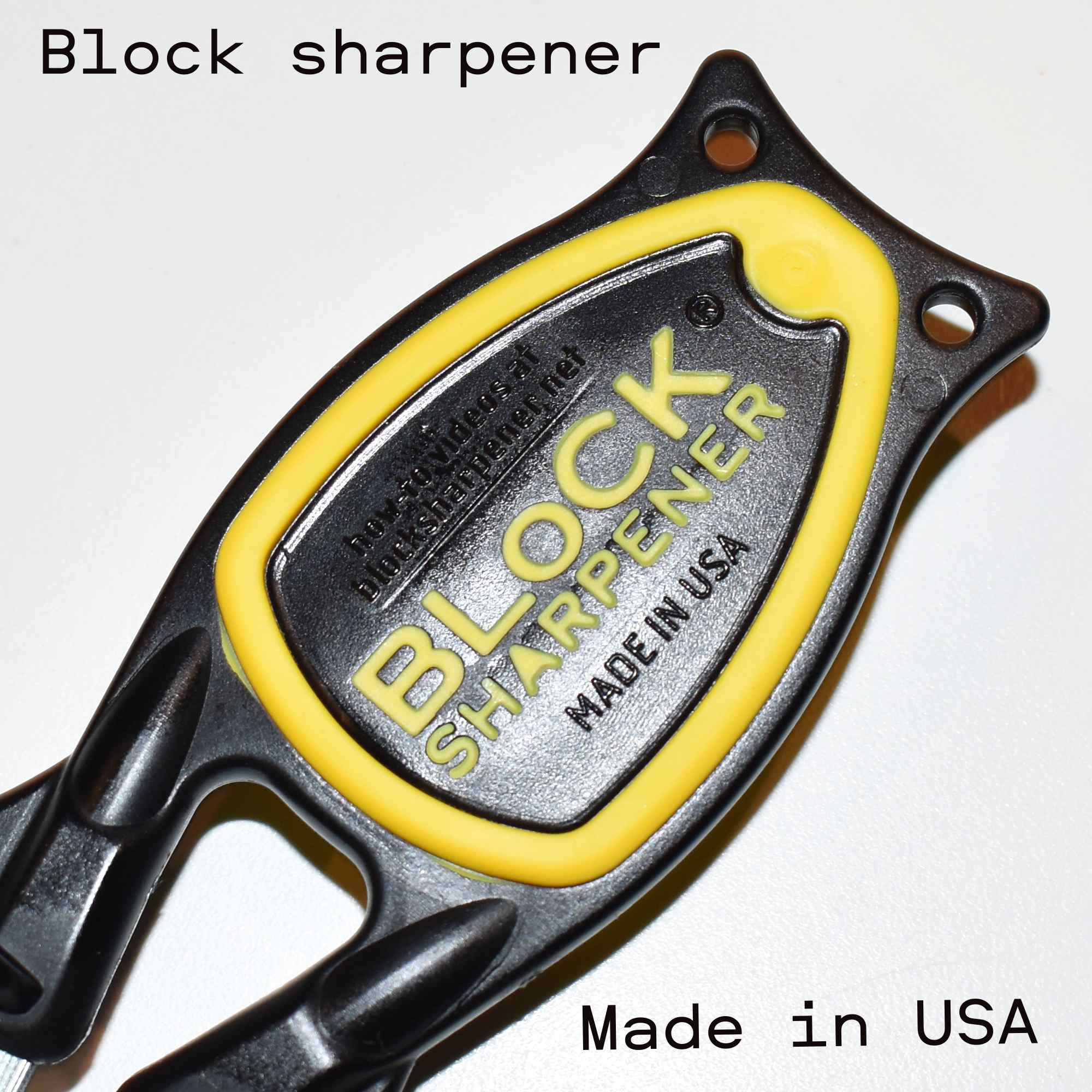 Bottom side of a Block sharpener with yellow grip