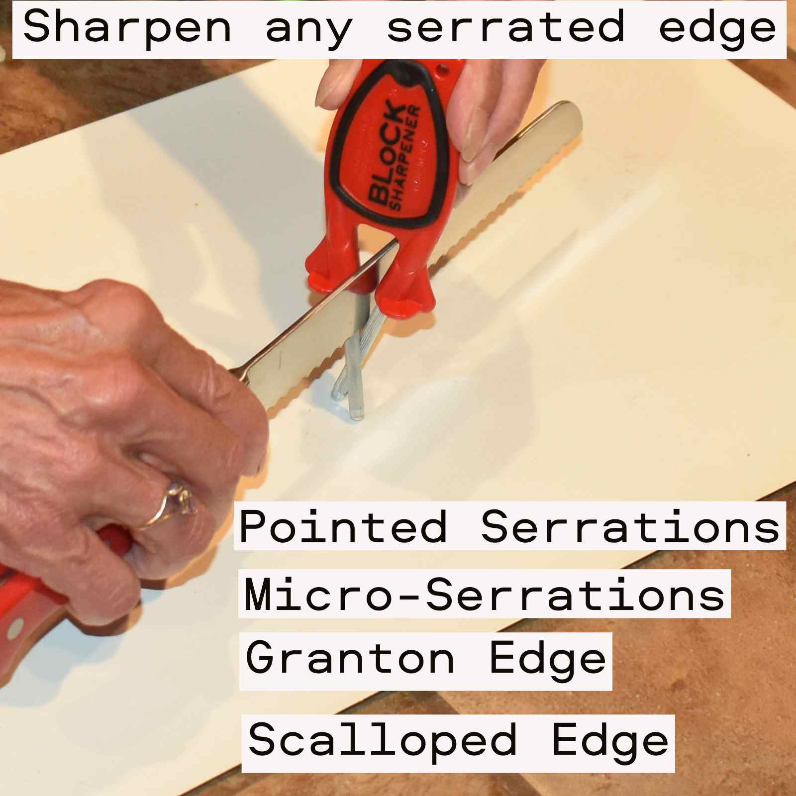 Serrated bread knife being sharpen on a Block red Block sharpener with Black grip