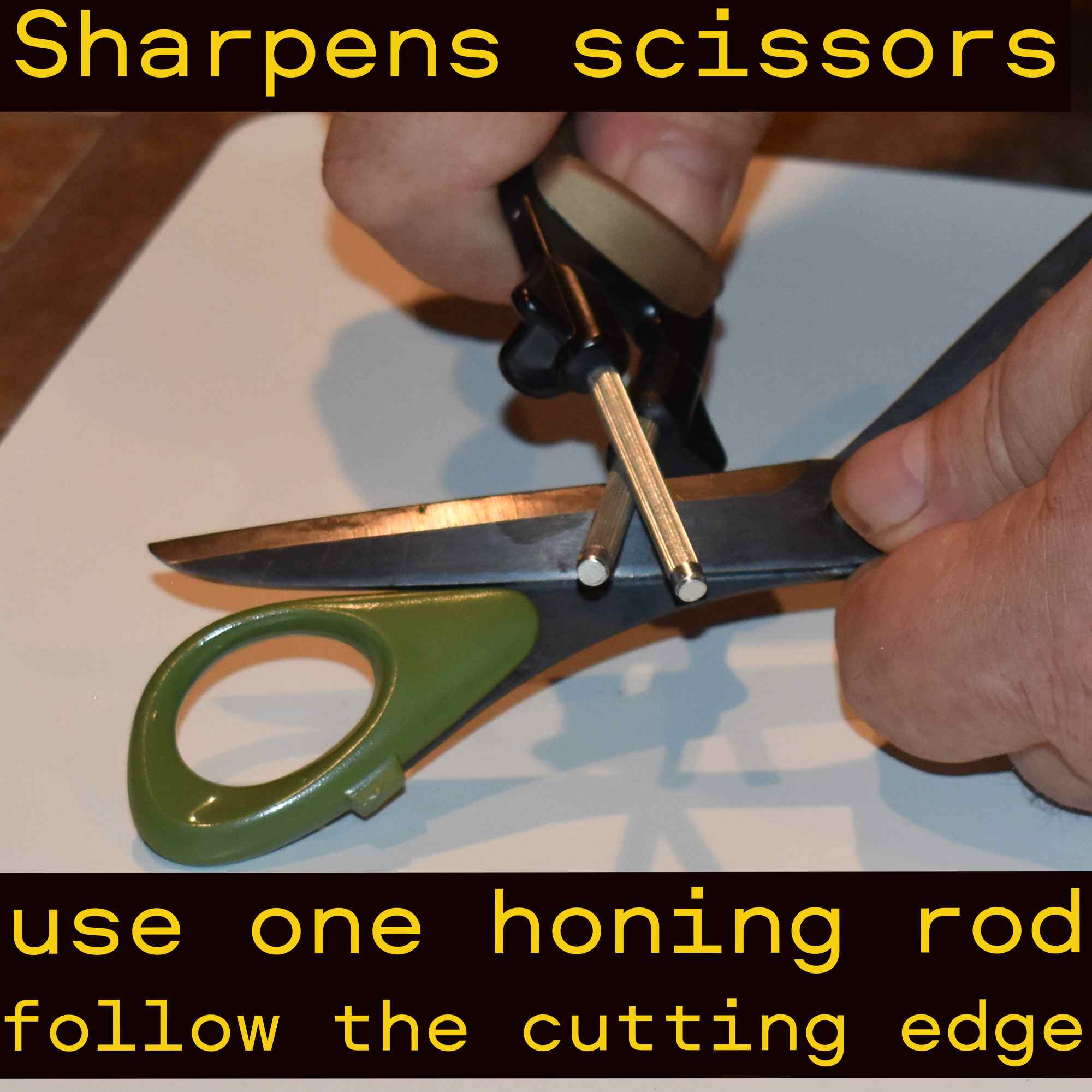 Sharping scissors with a Black and gold handheld knife sharpener.