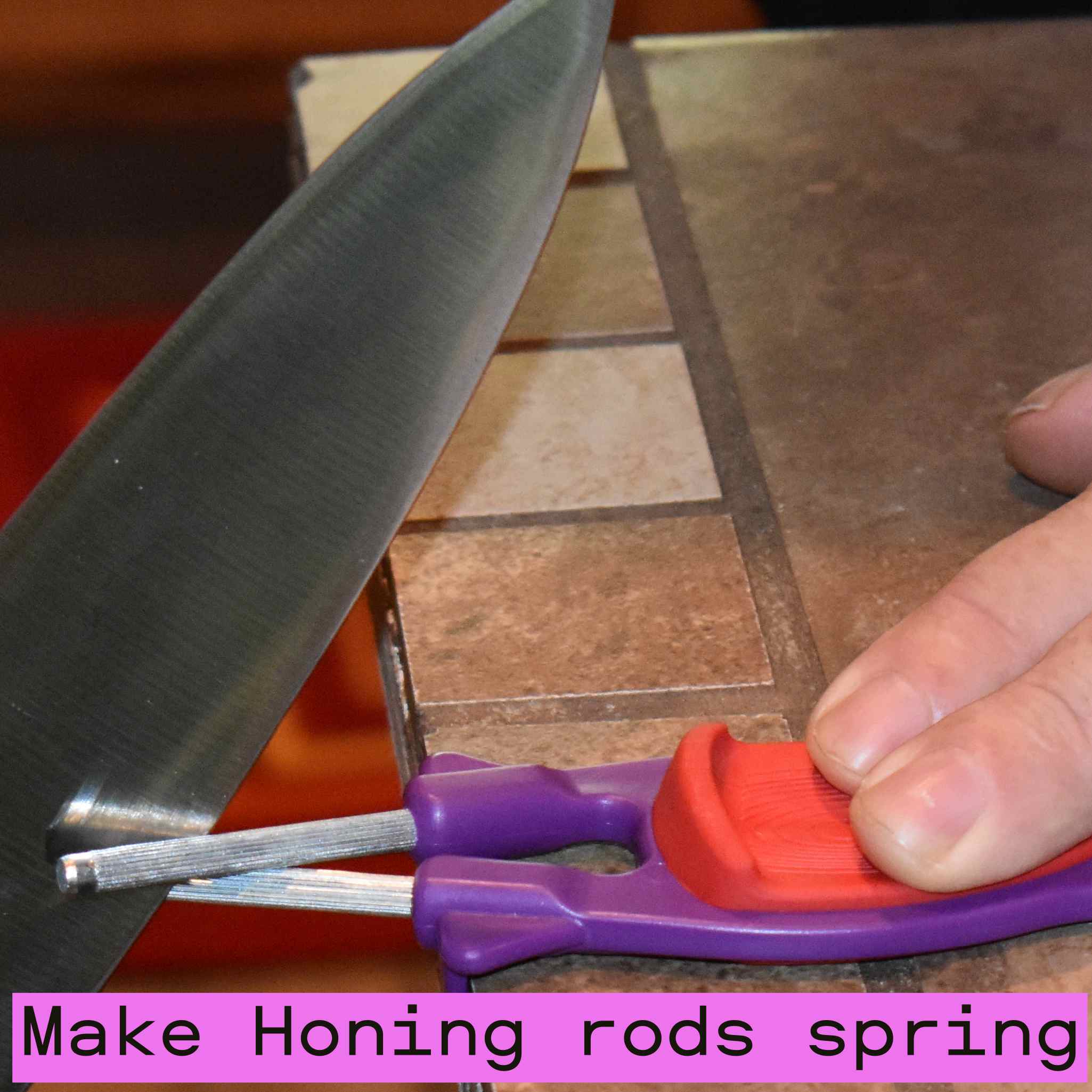 Sharpening a butcher knife using the best purple handheld knife sharpener with a red grip block.